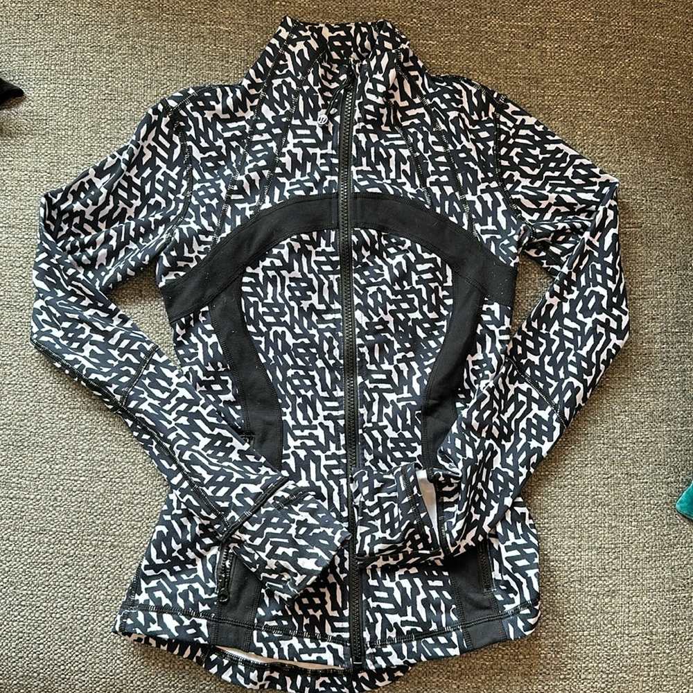 Lululemon zip up with finger holes.